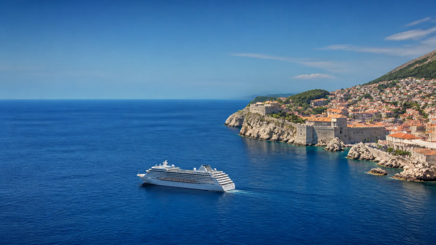 Cruise ship sailing near a Mediterranean coastal town